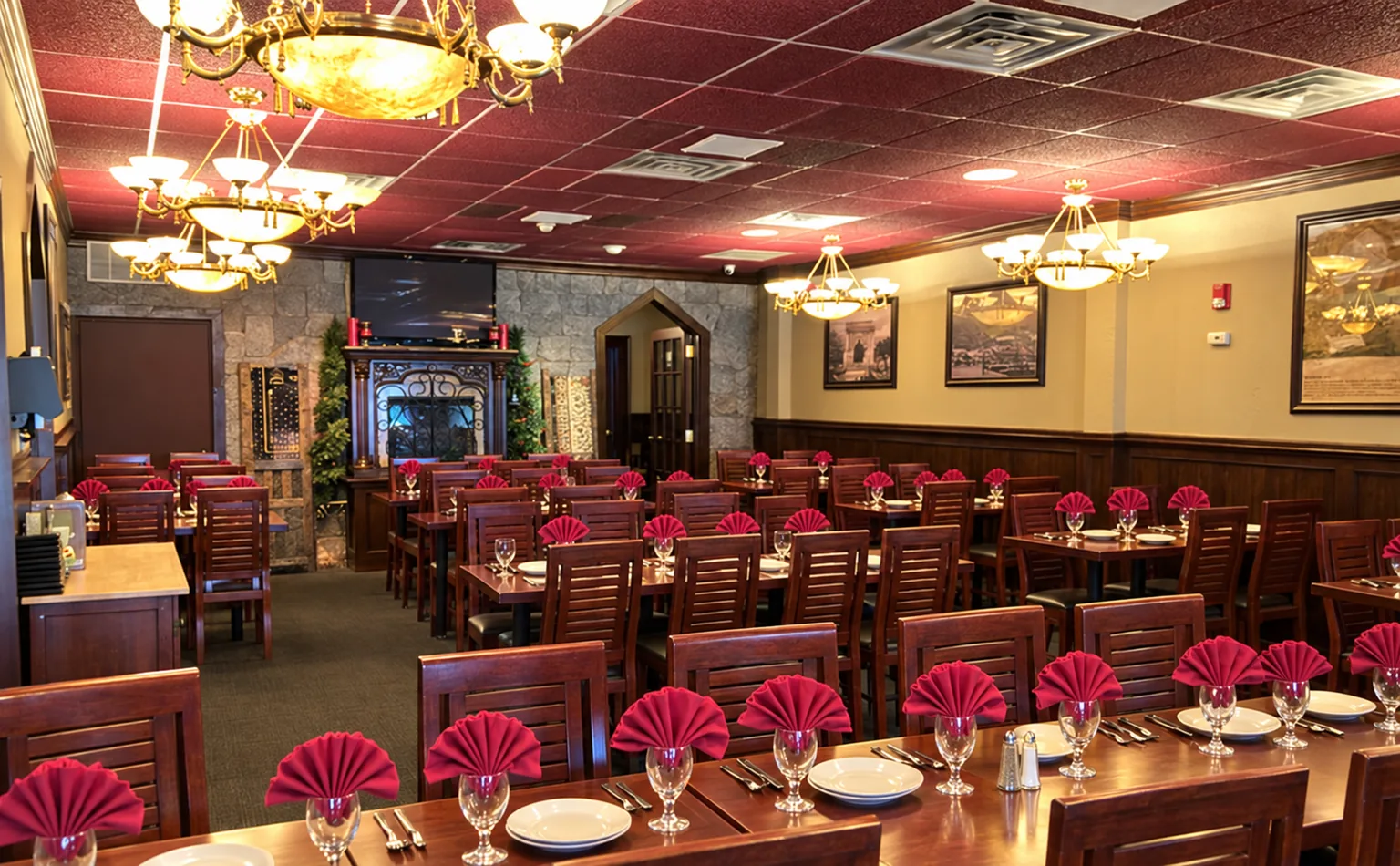 Illustrative event arrangement in Silk Road's dining room, with its burgundy ceiling, brass chandeliers and dark wood tables