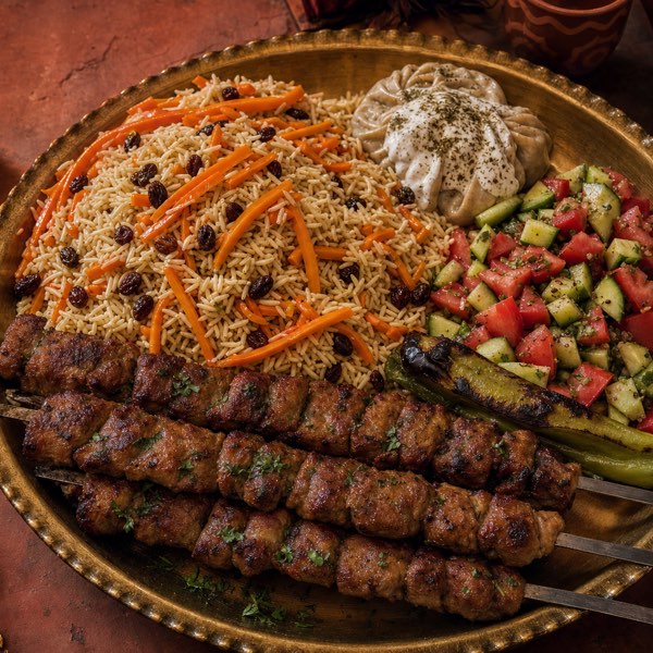 A Silk Road combination platter — kabob skewers with Kabli Palaw, mantu, and Afghan salad